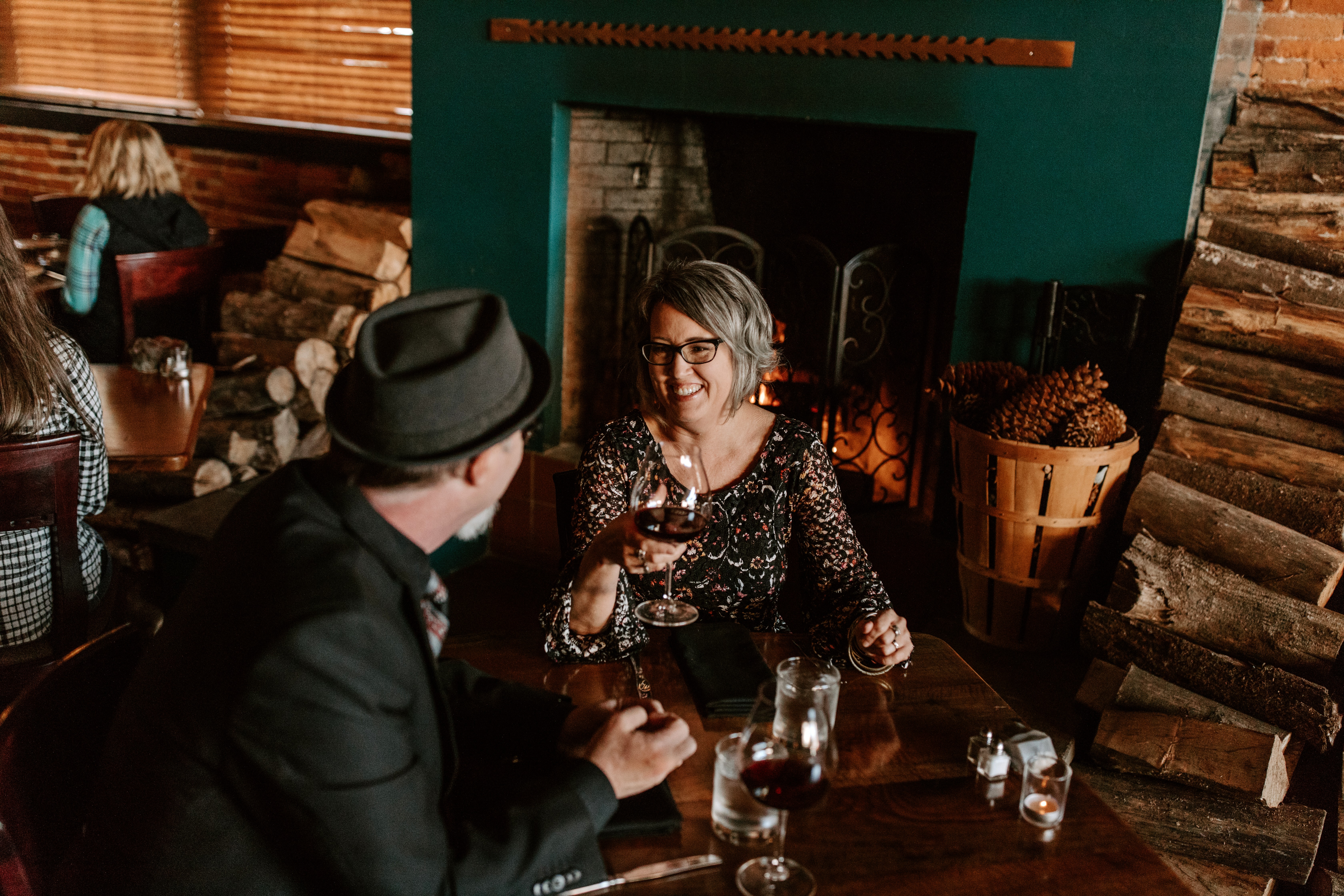 a couple dining next to Sybaris fireplace