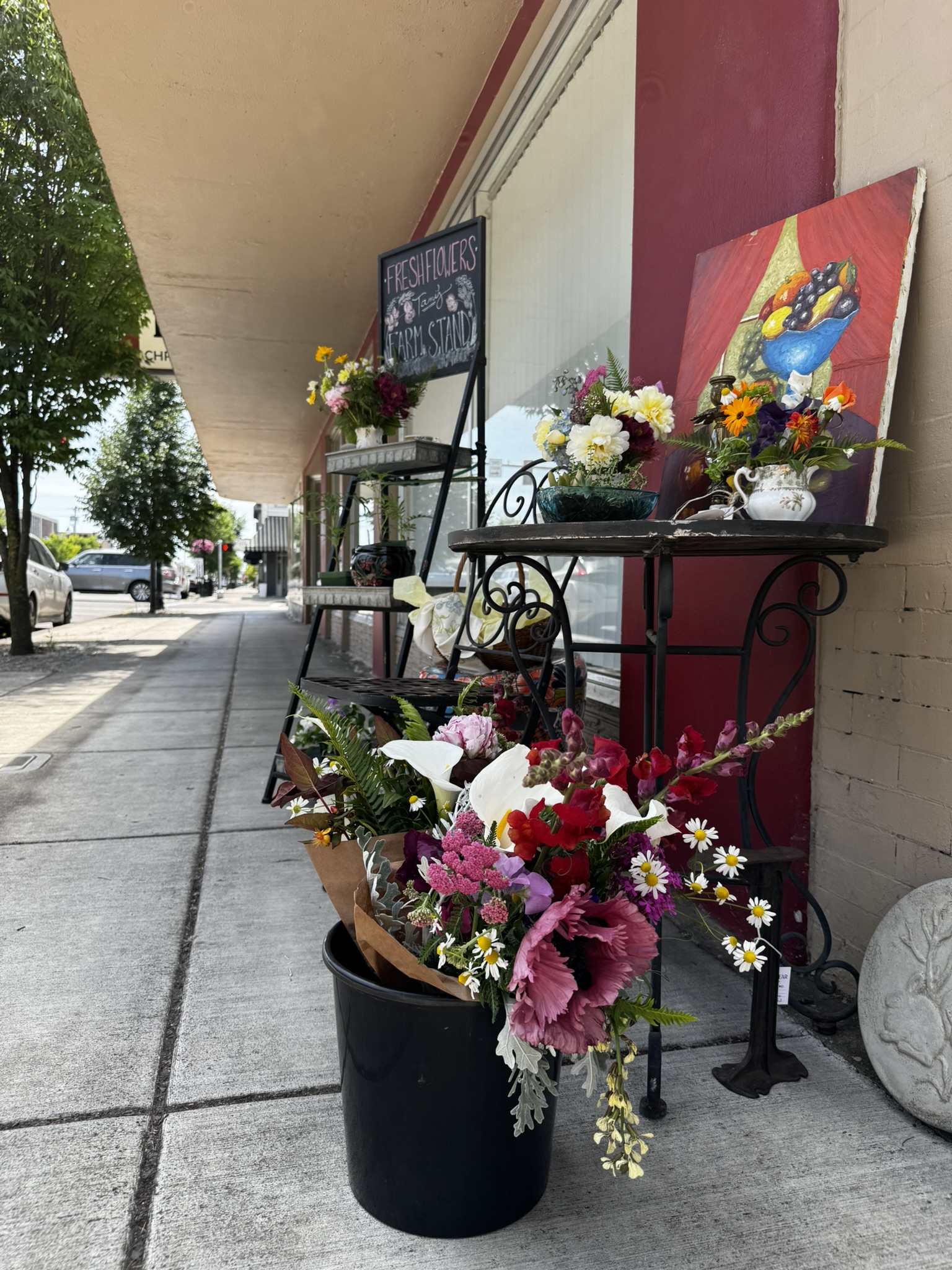 bucket of flowers outside a shop