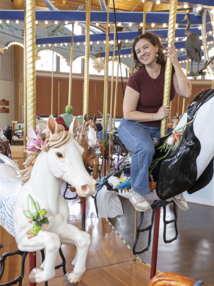 woman riding the orca at the carousel